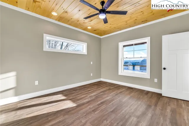 a bathroom with a granite countertop sink a mirror and shower