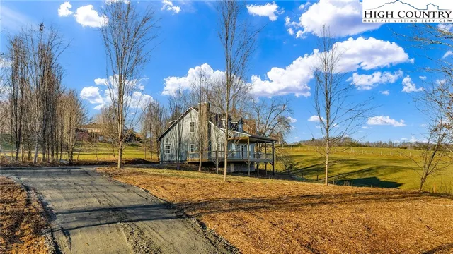 a view of a balcony with two chairs and a barbeque