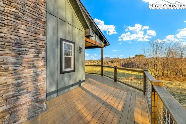 a view of balcony with floor to ceiling windows with wooden floor