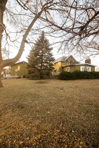 a front view of house with yard and trees