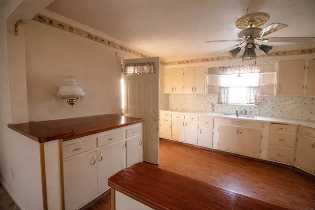a spacious bathroom with a granite countertop sink a mirror and shower