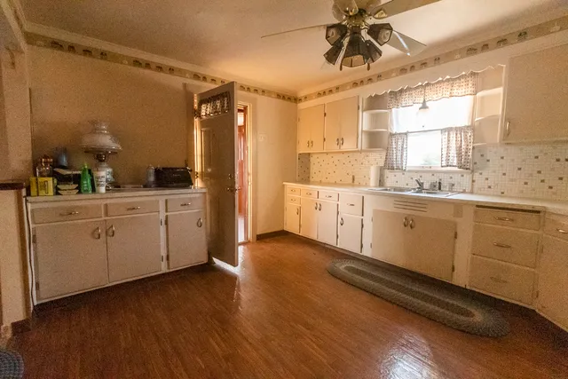 a kitchen with a sink cabinets and window