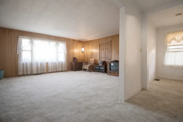 an empty room with furniture and a window