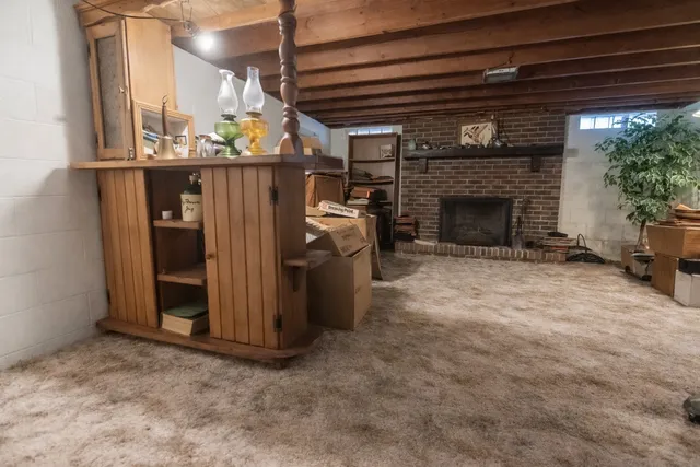 a view of a livingroom with furniture and fire place