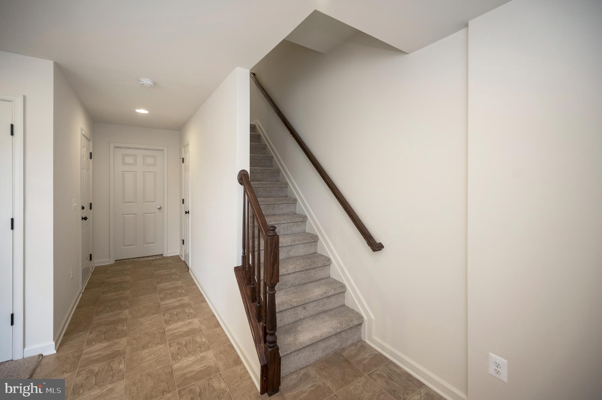 18323 Congressional Circle Ruther Glen, VA 22546 - Photo 11 of 75 Hallway to Den and Garage. Staircase to Main Level