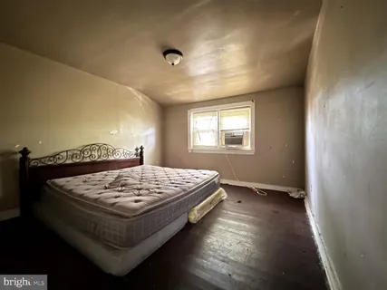 a bed sitting in a bedroom next to a window