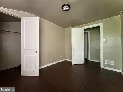 an empty room with wooden floor