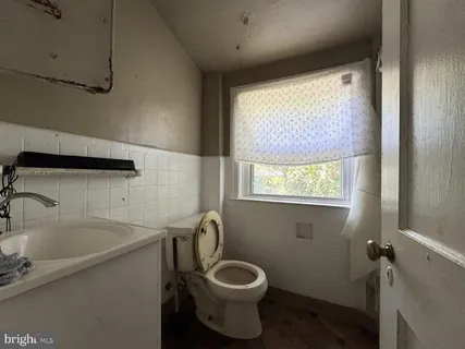 a bathroom with a toilet sink and window