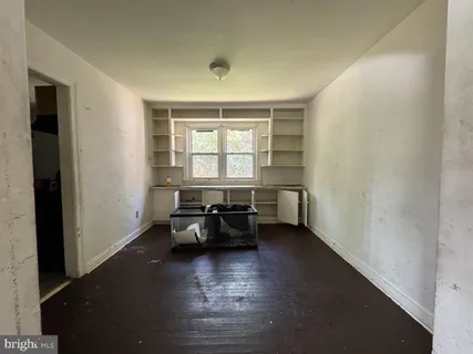 an empty room with furniture and window