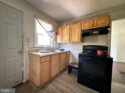 a kitchen with a sink cabinets and window
