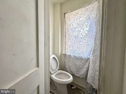 a bathroom with a sink toilet and a mirror