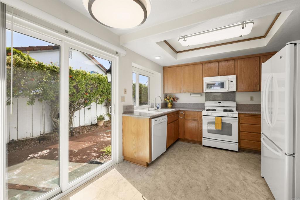 4125 Arcadia Way Oceanside, CA 92056 - Photo 15 of 51 a kitchen with white cabinets and white appliances