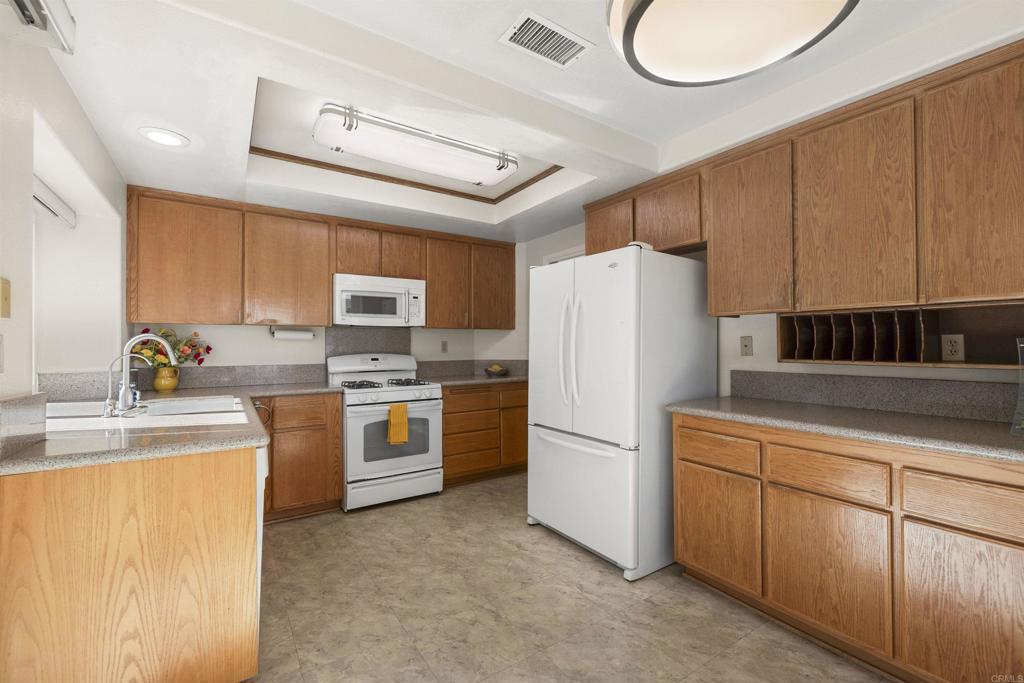 4125 Arcadia Way Oceanside, CA 92056 - Photo 16 of 51 a kitchen with stainless steel appliances granite countertop a refrigerator a stove top oven a sink and dishwasher