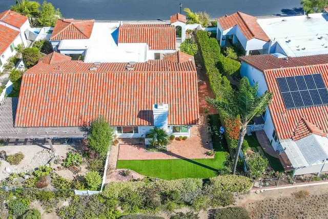 a front view of a house with garden and patio