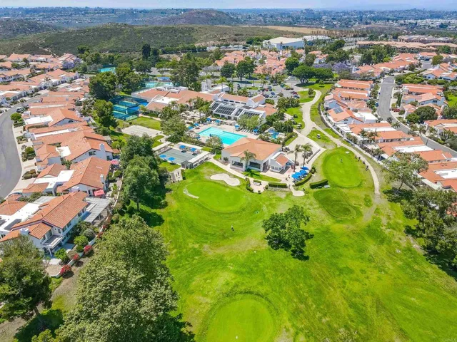 an aerial view of residential house with outdoor space and swimming pool