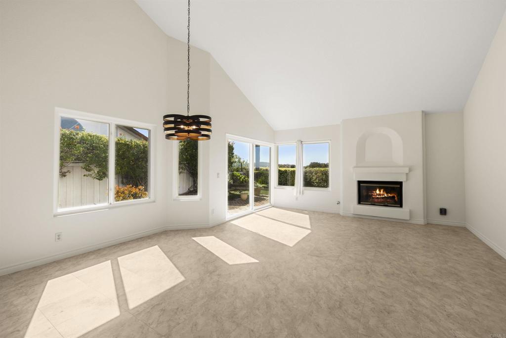 4125 Arcadia Way Oceanside, CA 92056 - Photo 5 of 51 a view of an empty room with a fireplace and windows