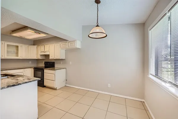 a kitchen that has a lot of cabinets and appliances