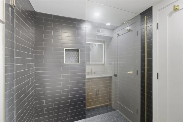 a bathroom with a shower and a glass door