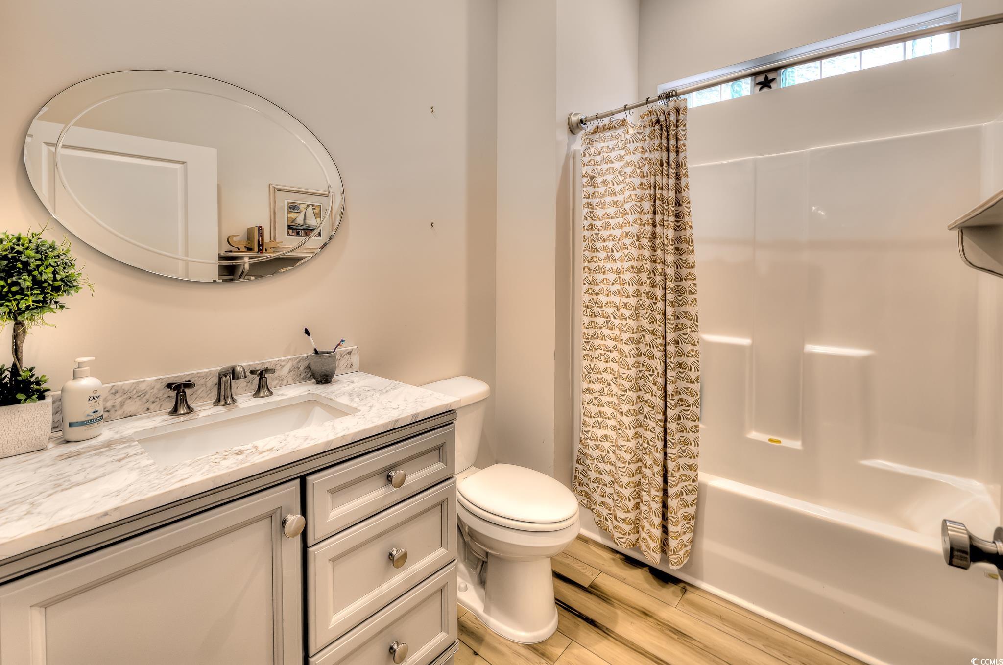 10 Saltwater Way Murrells Inlet, SC 29576 - Photo 18 of 30 Full bathroom with vanity, shower / tub combo, woo