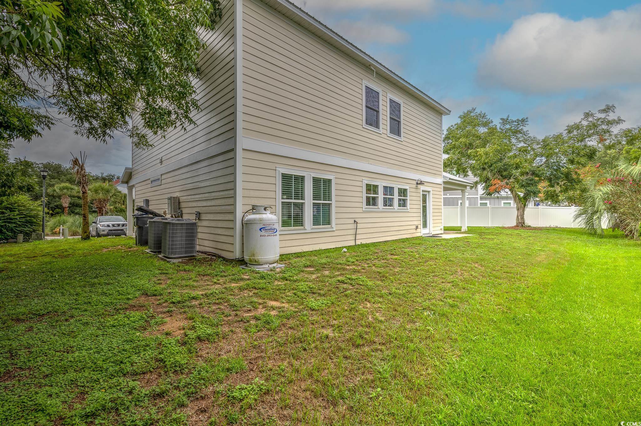 10 Saltwater Way Murrells Inlet, SC 29576 - Photo 23 of 30 Rear view of house with a yard and central AC unit
