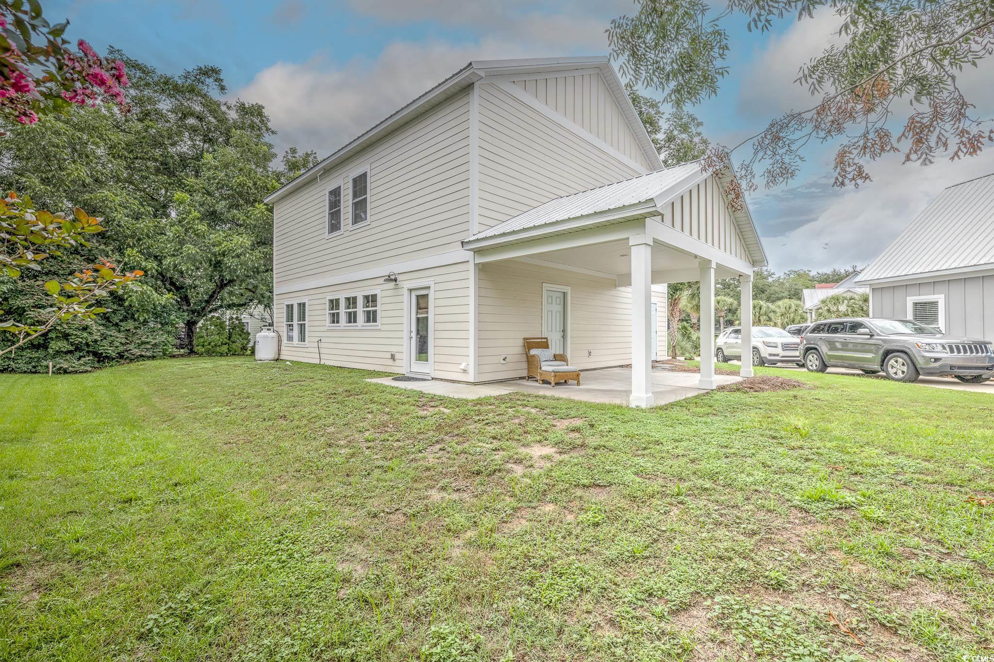 10 Saltwater Way Murrells Inlet, SC 29576 - Photo 3 of 30 View of side of home featuring a patio area and a