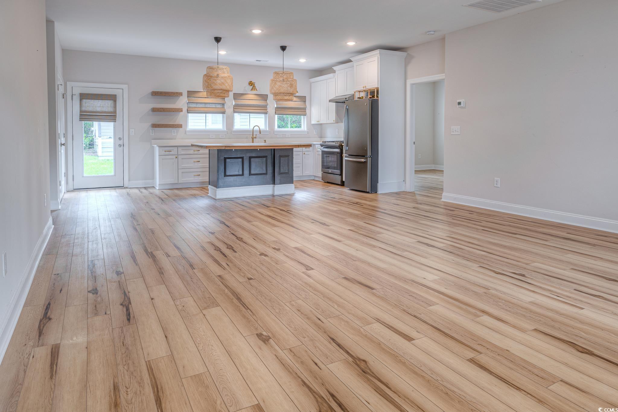 10 Saltwater Way Murrells Inlet, SC 29576 - Photo 6 of 30 Unfurnished living room with sink and light hardwo