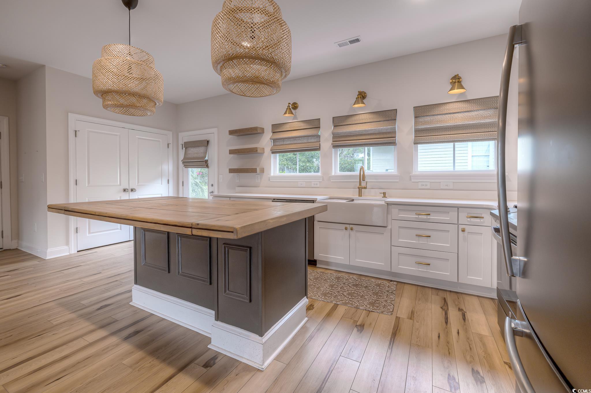 10 Saltwater Way Murrells Inlet, SC 29576 - Photo 8 of 30 Kitchen with white cabinetry, sink, butcher block
