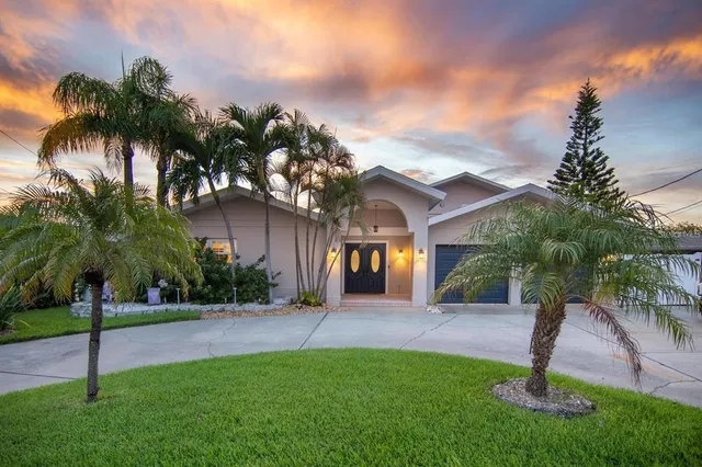 a front view of house with yard and green space