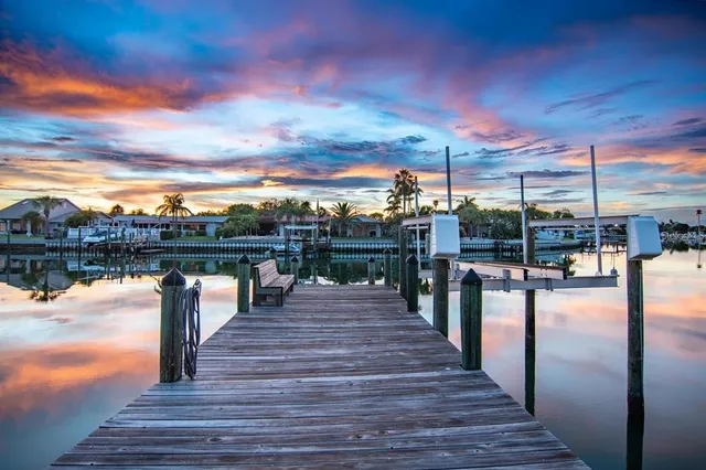 a large bed sitting in a bedroom next to a window