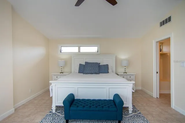 a bedroom with a bed a fireplace and a flat tv screen