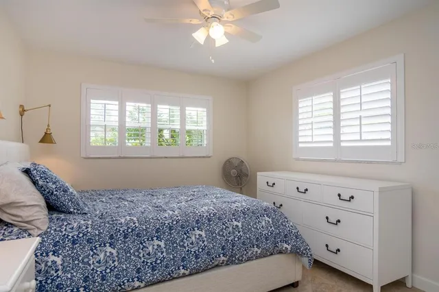 a bedroom with a large bed and a flat tv screen