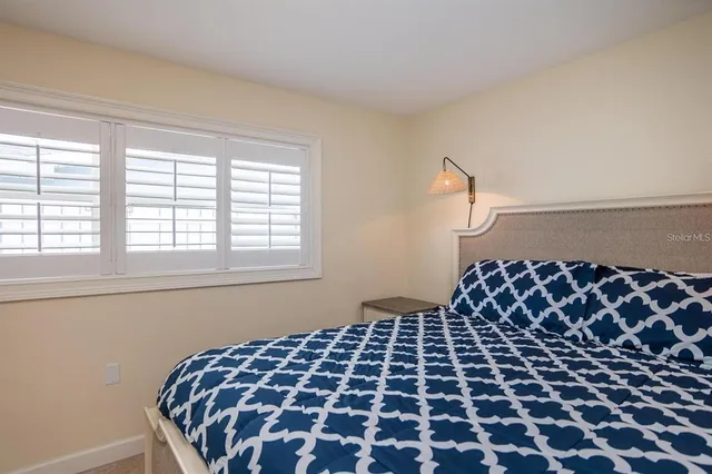 a bathroom with a granite countertop toilet sink and mirror