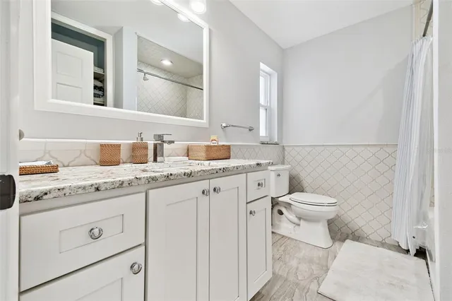 a kitchen with granite countertop white cabinets and a white counter tops