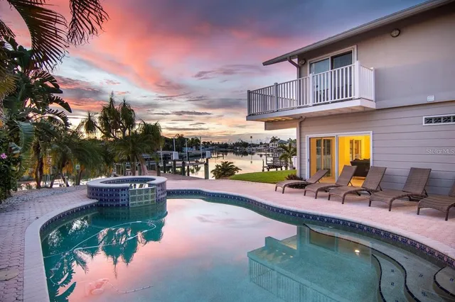 a dining room with furniture a chandelier and wooden floor