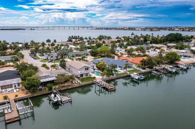 a view of a swimming pool with a lake view and sitting area