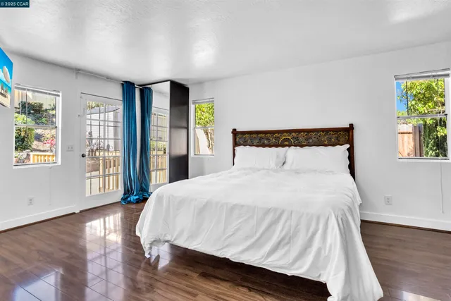 a bedroom with a large bed and a large window