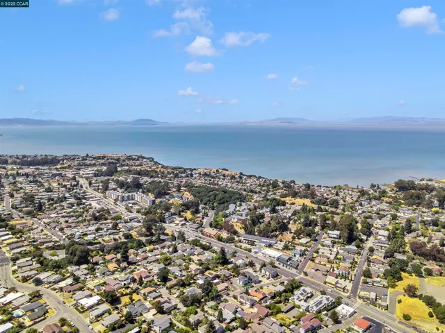 an aerial view of residential building and trees around