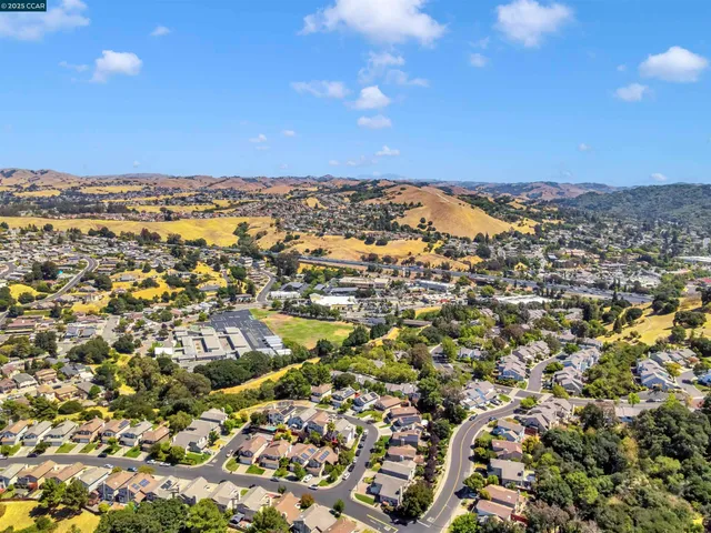 a front view of a house with a garden and yard