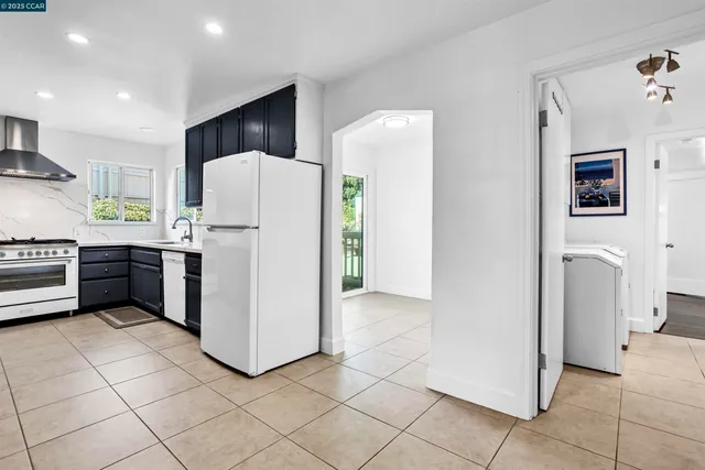 a kitchen with a refrigerator and a stove top oven