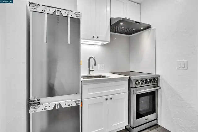 a kitchen with a stove and a refrigerator