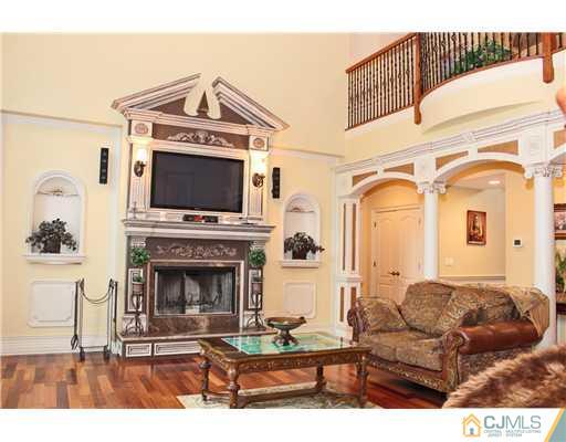 6 Ramsey Road Edison, NJ 08820 - Photo 11 of 25 a living room with furniture a flat screen tv and a fireplace