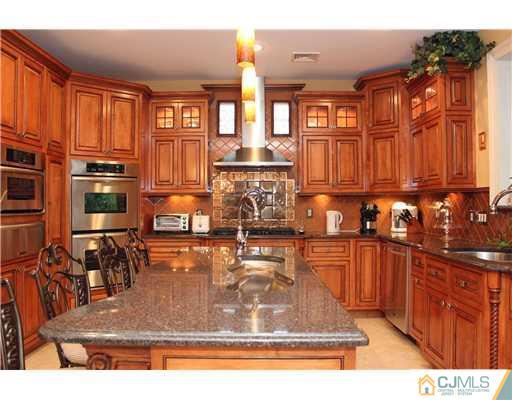 6 Ramsey Road Edison, NJ 08820 - Photo 15 of 25 a view of a kitchen with kitchen island granite countertop a large counter top space and stainless steel appliances