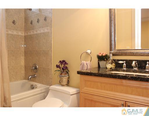 6 Ramsey Road Edison, NJ 08820 - Photo 21 of 25 a bathroom with a sink a mirror and a bathtub