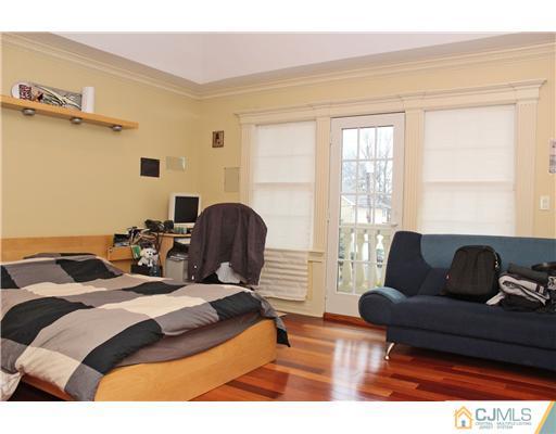 6 Ramsey Road Edison, NJ 08820 - Photo 22 of 25 a bedroom with a bed and wooden floor