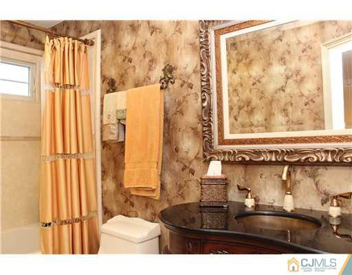 6 Ramsey Road Edison, NJ 08820 - Photo 23 of 25 a bathroom with a sink and a mirror