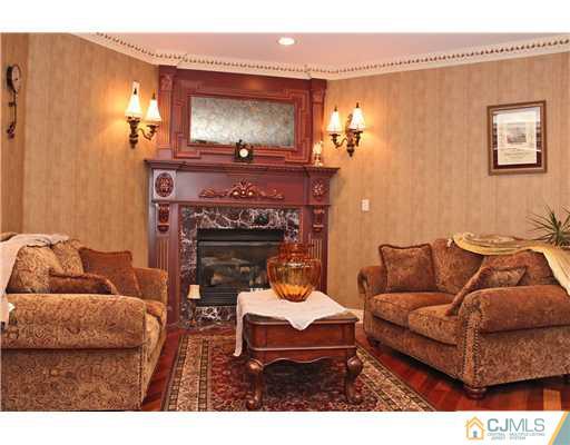 6 Ramsey Road Edison, NJ 08820 - Photo 10 of 25 a living room with furniture and a fireplace