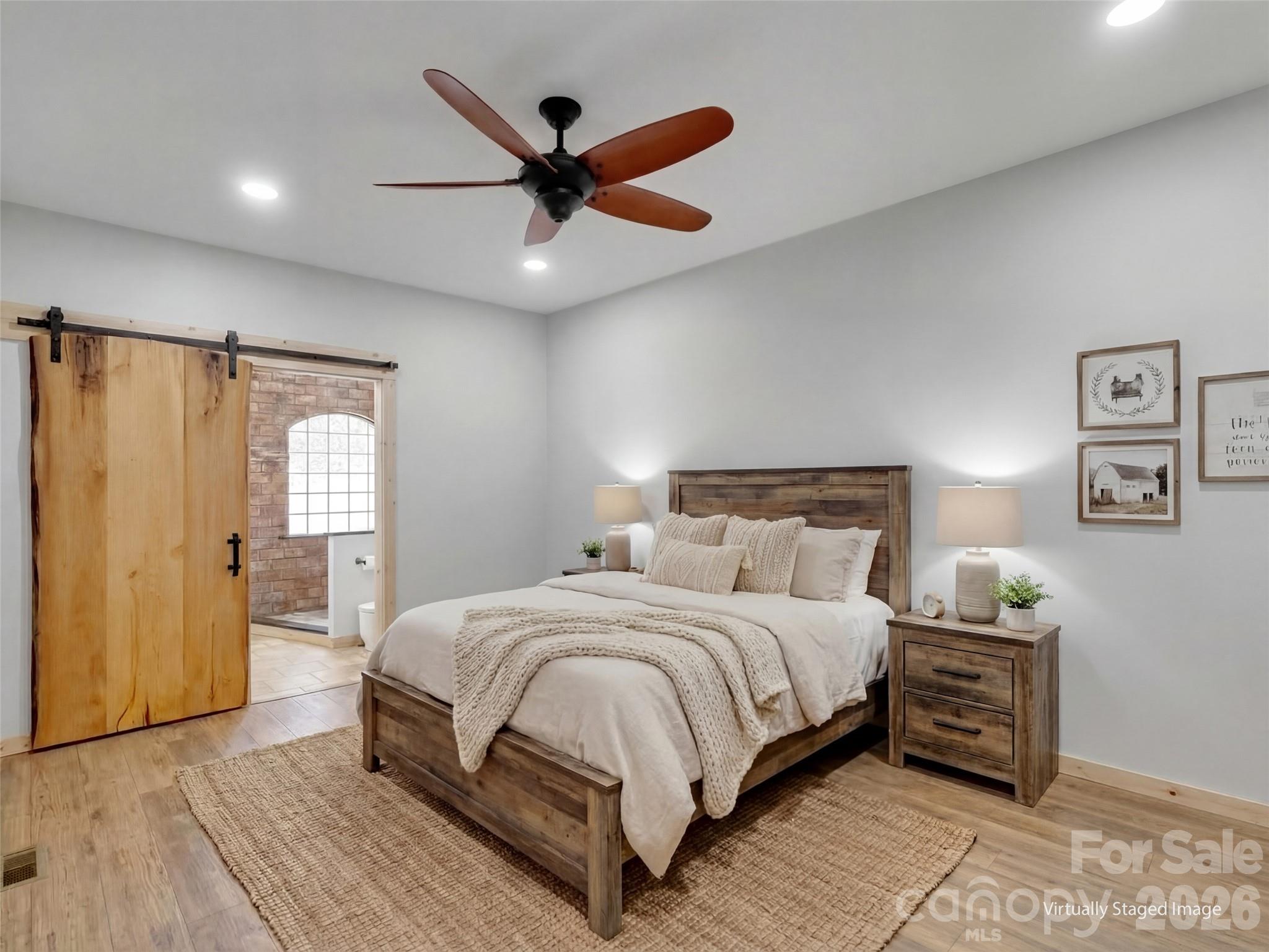 171 Cowtail Cove Clyde, NC 28721 - Photo 13 of 48 a bedroom with a large bed and a ceiling fan