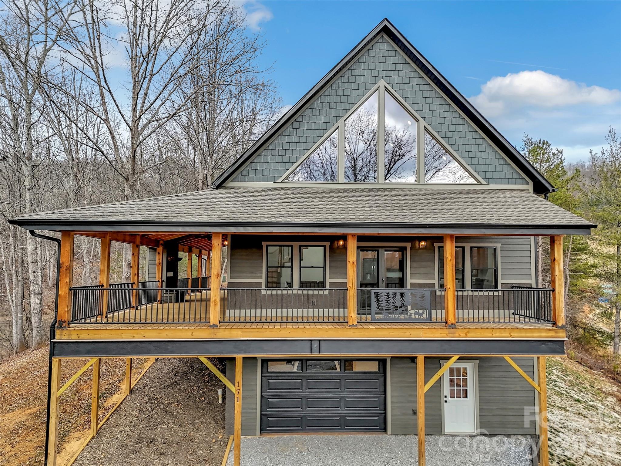 171 Cowtail Cove Clyde, NC 28721 - Photo 3 of 48 front view of house with large windows and a table