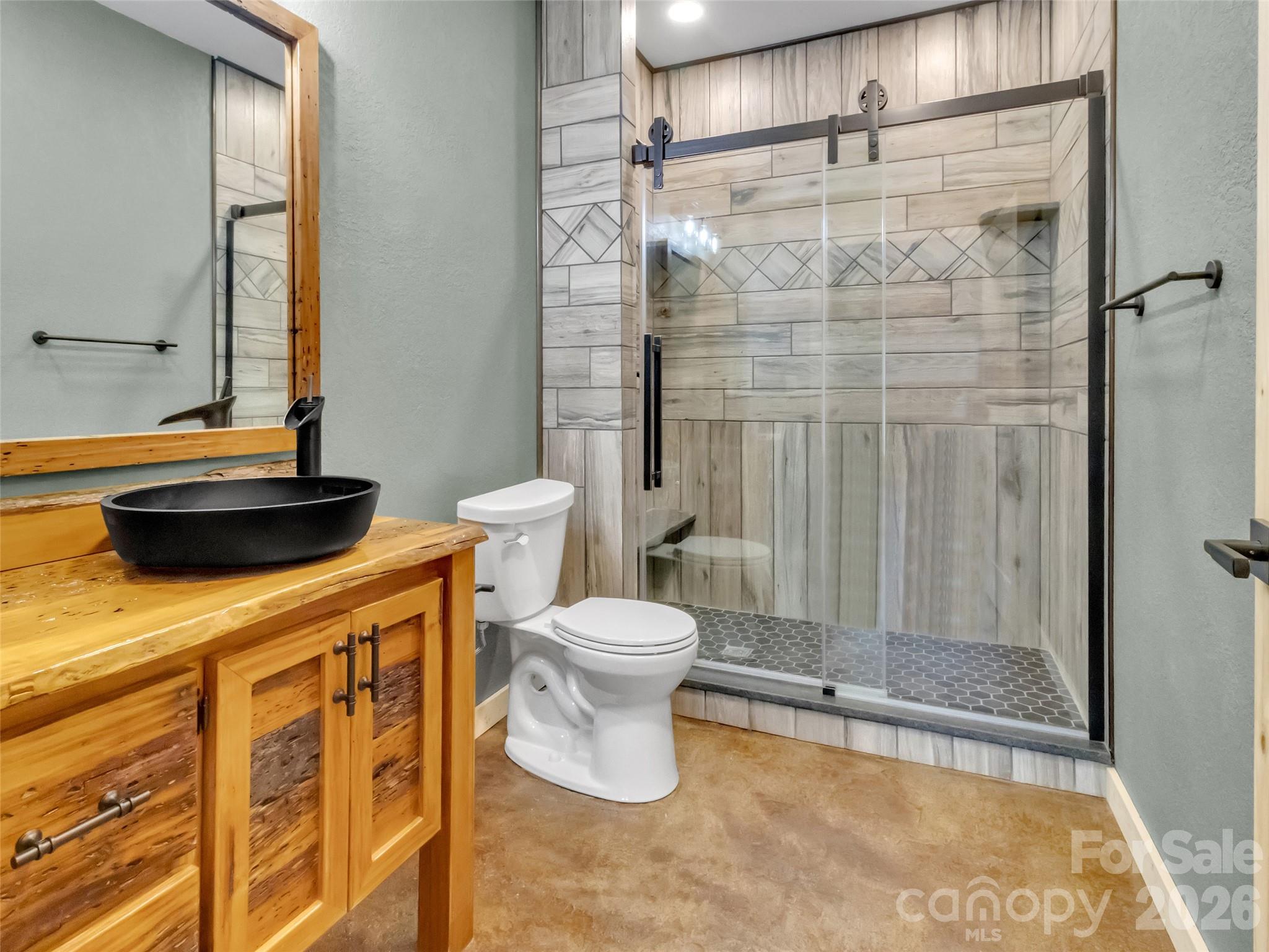171 Cowtail Cove Clyde, NC 28721 - Photo 37 of 48 a bathroom with a bathtub and a shower