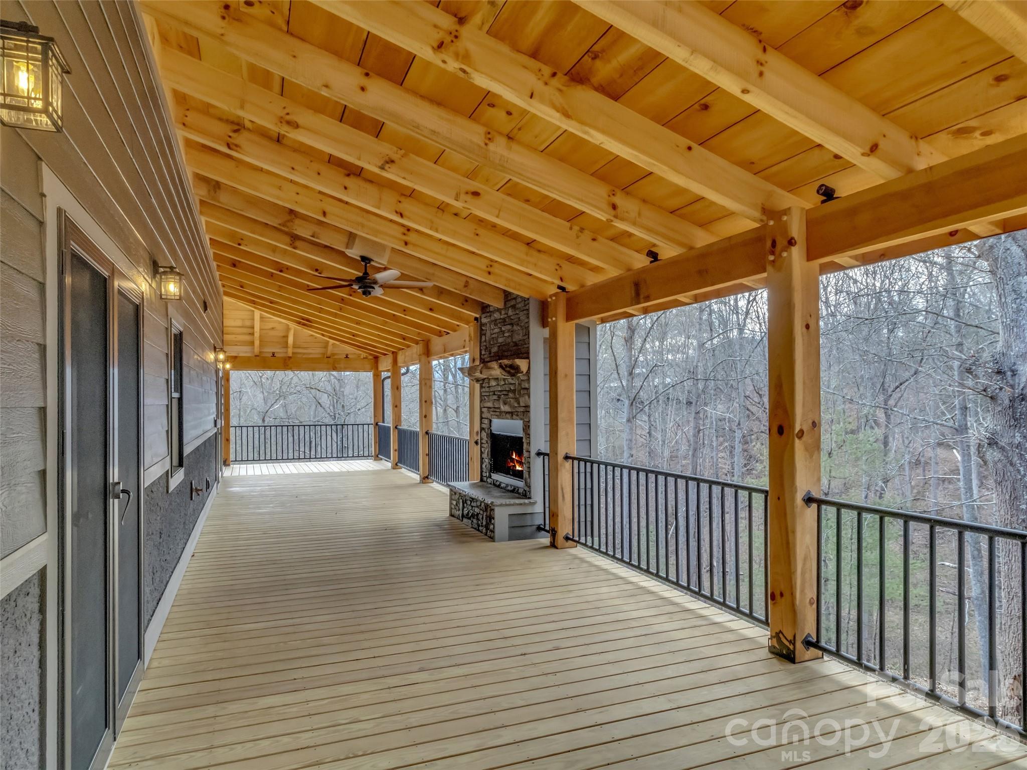 171 Cowtail Cove Clyde, NC 28721 - Photo 41 of 48 a view of a porch with wooden floor and iron stairs